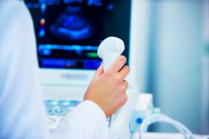 Abdominal sonographer performing ultrasound