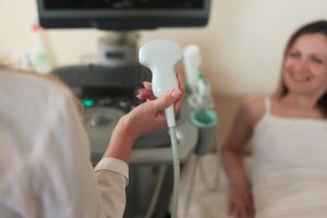 Sonographer conducting ultrasound on patient